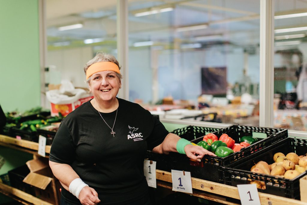 Sister Rita Malavisi in running gear inside Foodbank